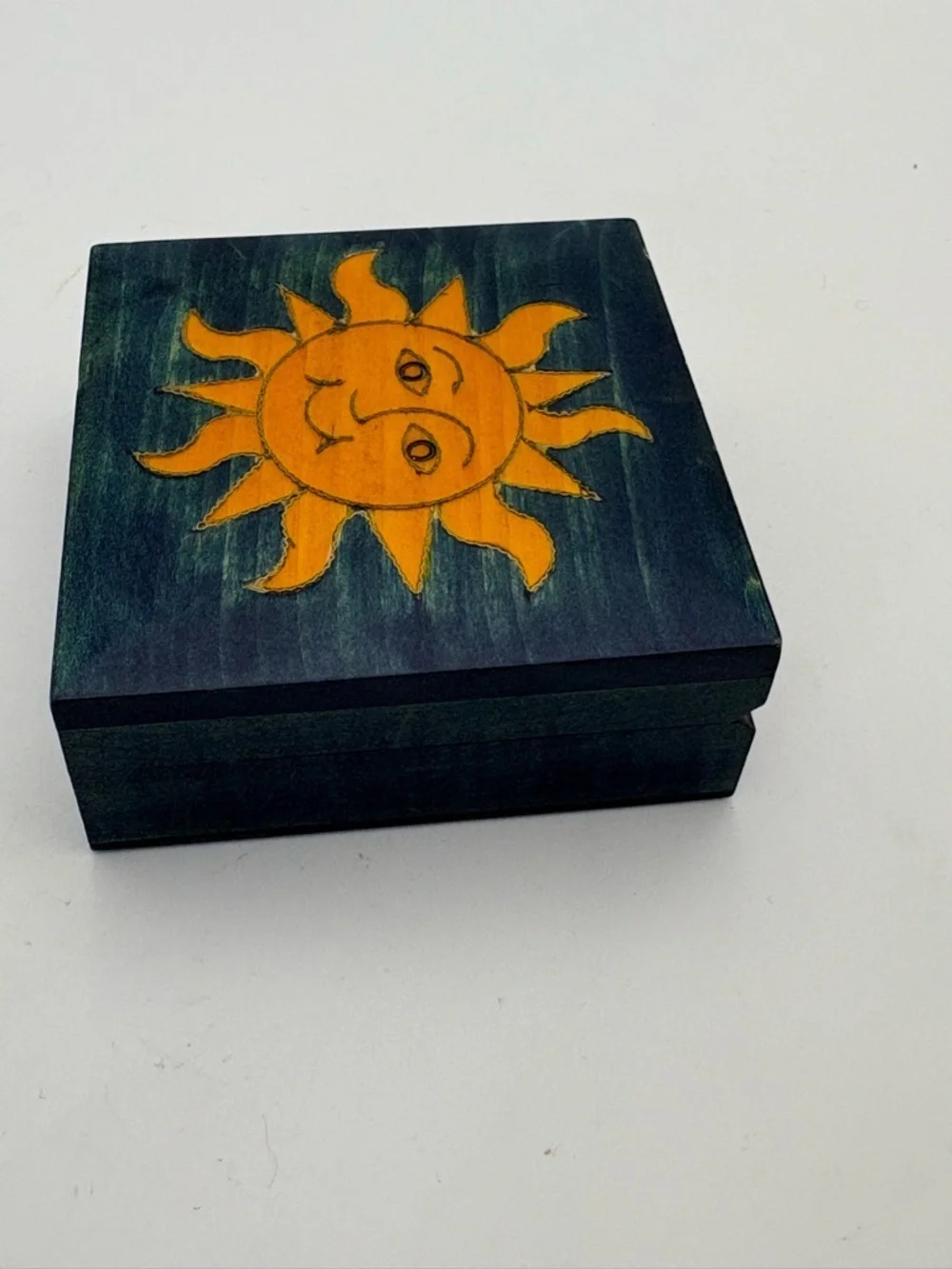 Bright Yellow Sun on Deep Blue Wooden Box